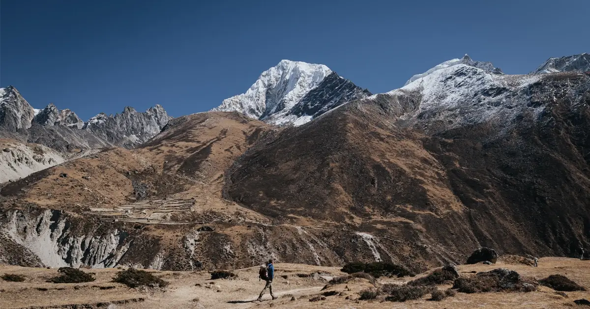 Trekker, enjoying the walk on the Gokyo route with scene of mountains