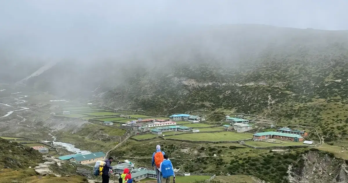 Trekkers, enjoying vistas of Machhermo Village on the way to Gokyo Valley